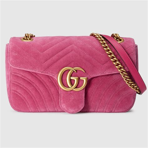 pink velvet gucci purse.